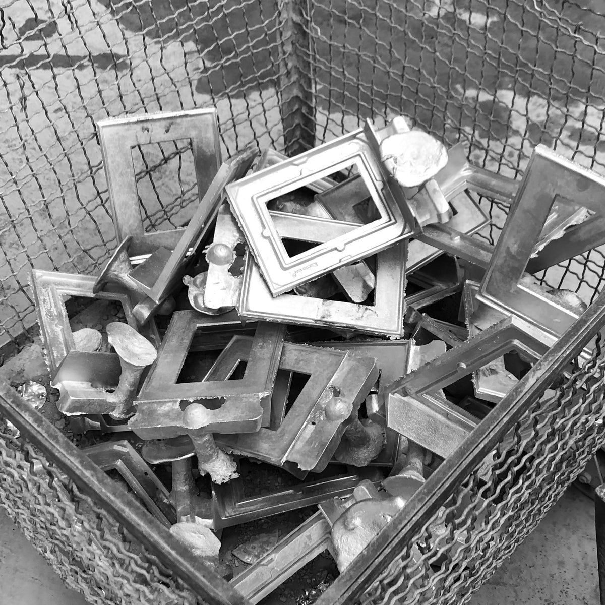 Scrap aluminum pieces that will be melted down and used in additional sand cast molds
